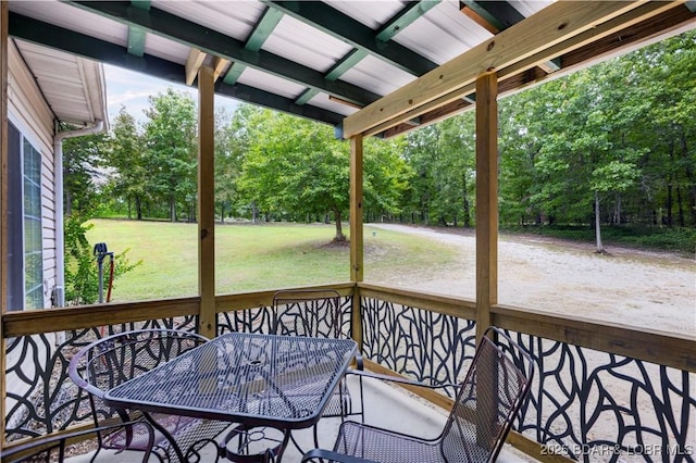 exterior space featuring a lawn and outdoor dining space