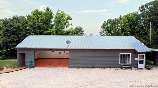 view of front of property with an outbuilding, metal roof, and a detached garage