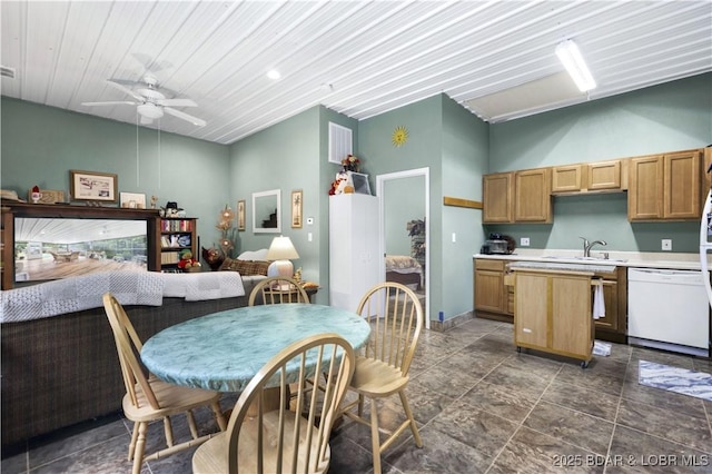 kitchen featuring visible vents, a ceiling fan, dishwasher, a center island, and light countertops