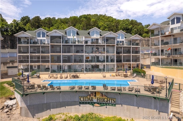 community pool featuring a patio area and fence