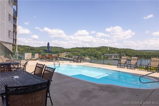 pool featuring a patio area and fence