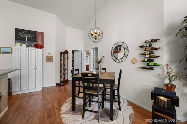 dining space featuring baseboards, high vaulted ceiling, and dark wood-style flooring