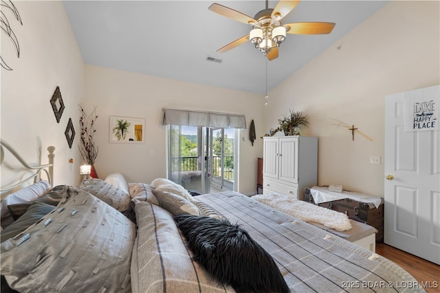 bedroom featuring visible vents, ceiling fan, wood finished floors, access to outside, and vaulted ceiling