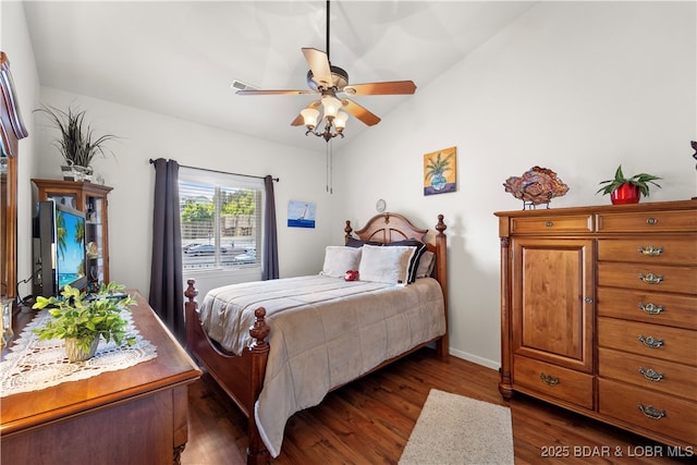 bedroom featuring lofted ceiling, ceiling fan, dark wood-style flooring, and baseboards