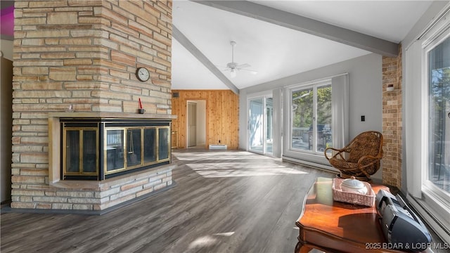 living area with beam ceiling, high vaulted ceiling, a ceiling fan, wood finished floors, and a fireplace