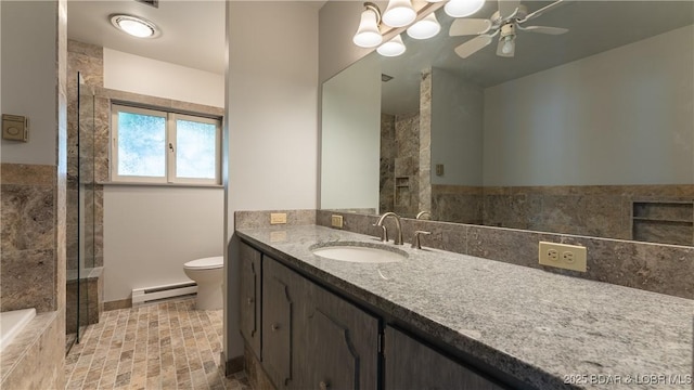 bathroom featuring a baseboard heating unit, ceiling fan, toilet, tiled shower, and vanity