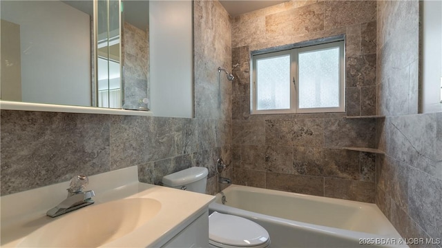 full bathroom featuring shower / bathing tub combination, toilet, tile walls, and vanity