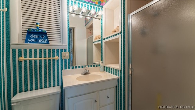 bathroom with toilet, a stall shower, wallpapered walls, and vanity