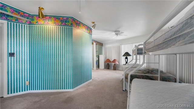 bedroom featuring a ceiling fan and carpet