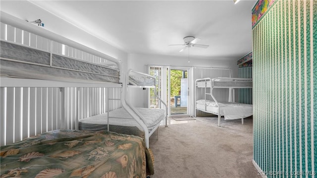 carpeted bedroom featuring access to exterior and a ceiling fan