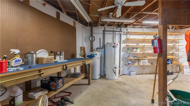 unfinished below grade area featuring gas water heater, a workshop area, and water heater