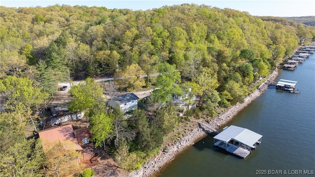 aerial view with a forest view and a water view