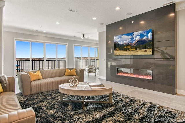 living room with recessed lighting, visible vents, a large fireplace, and baseboards