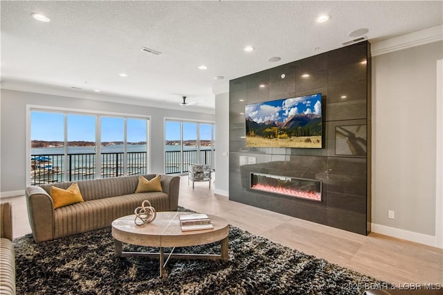 living room with visible vents, recessed lighting, a fireplace, and baseboards