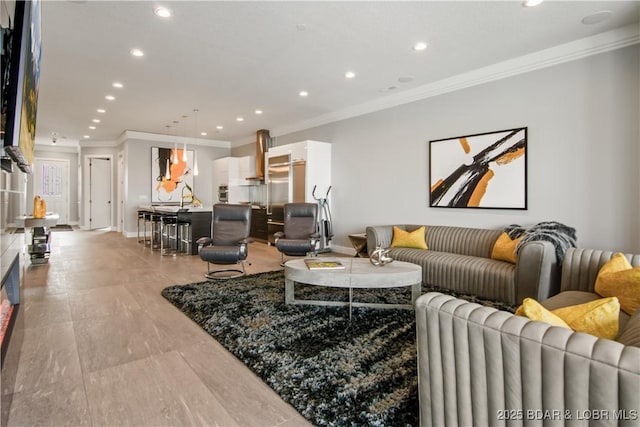 living area featuring recessed lighting, radiator heating unit, and ornamental molding