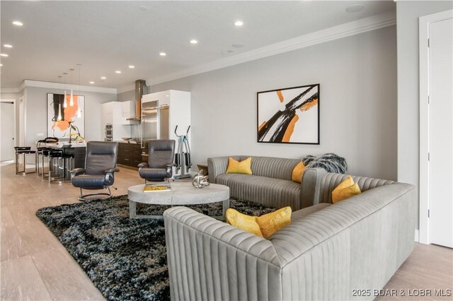 living area with recessed lighting, light wood-style flooring, and crown molding