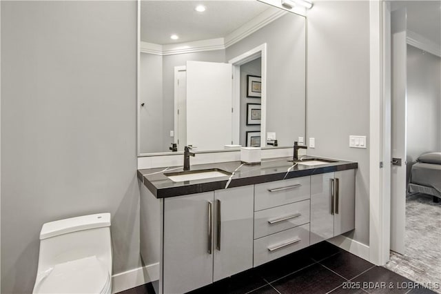 full bathroom featuring a sink, toilet, double vanity, and crown molding