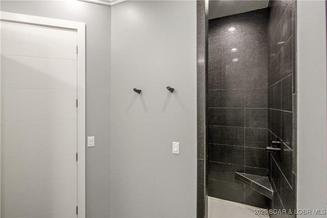 bathroom with tiled shower