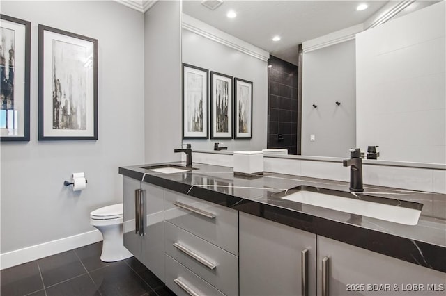 bathroom featuring tile patterned floors, toilet, recessed lighting, and a sink