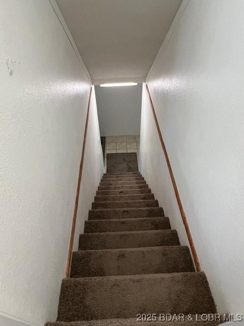 stairway featuring tile patterned floors