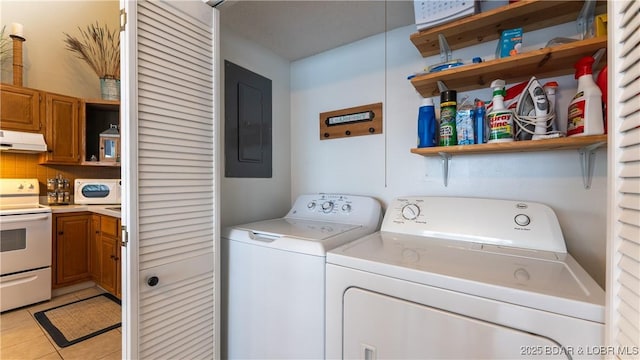 laundry room featuring laundry area, electric panel, washer and clothes dryer, and light tile patterned floors