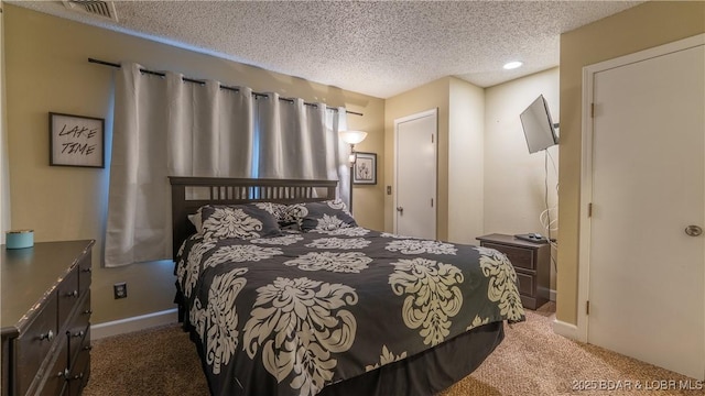 bedroom featuring carpet, visible vents, a textured ceiling, and baseboards