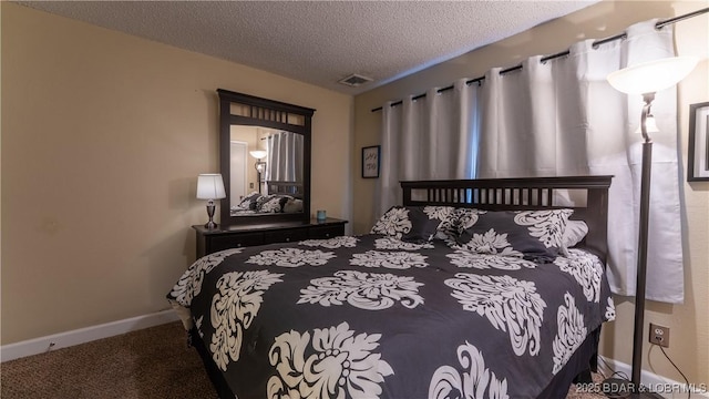 bedroom featuring carpet floors, baseboards, visible vents, and a textured ceiling