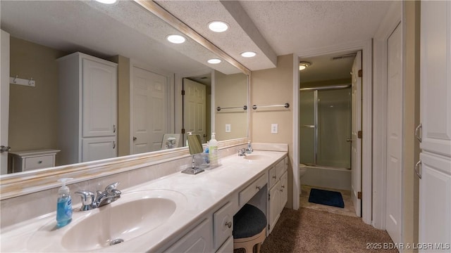 bathroom with recessed lighting, a sink, a textured ceiling, and double vanity