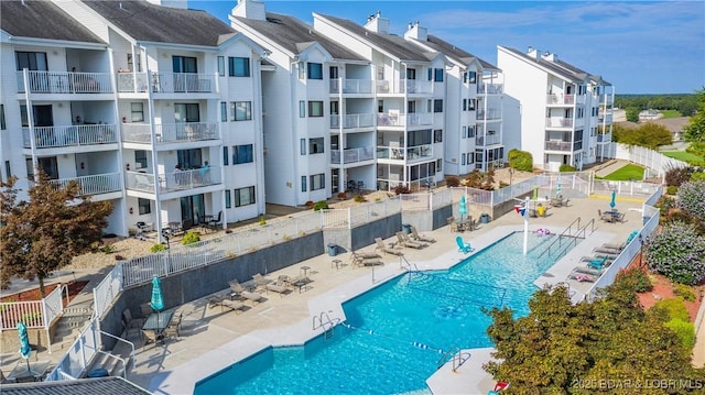 pool featuring fence and a patio