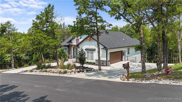 399 W End Cir, Osage Beach, MO 65065 - view of front of house featuring a garage, driveway, a shingled roof, and stone siding