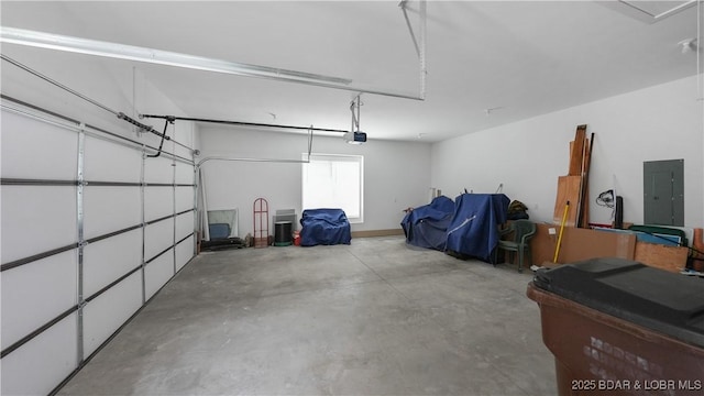 garage with electric panel and a garage door opener