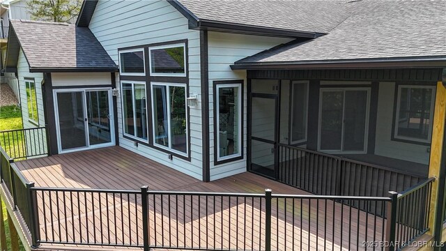 399 W End Cir, Osage Beach, MO 65065 - rear view of property with a shingled roof, a sunroom, and a wooden deck