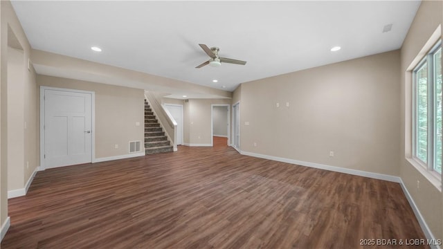 unfurnished room with recessed lighting, wood finished floors, visible vents, baseboards, and stairway