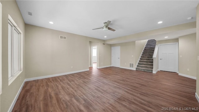 unfurnished room with baseboards, stairway, wood finished floors, and recessed lighting