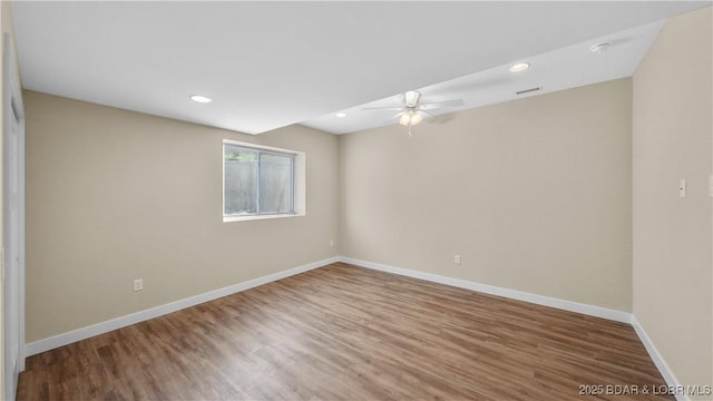 empty room with visible vents, baseboards, ceiling fan, wood finished floors, and recessed lighting