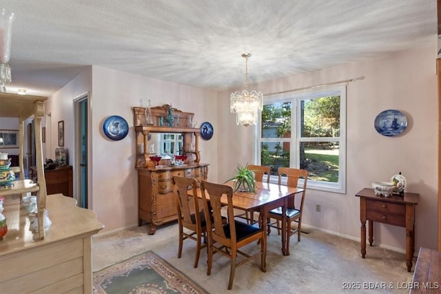 dining area featuring baseboards, light carpet, and an inviting chandelier