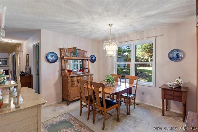 192 Mayfair Dr, Camdenton, MO 65020 - dining space with a chandelier, light carpet, and baseboards