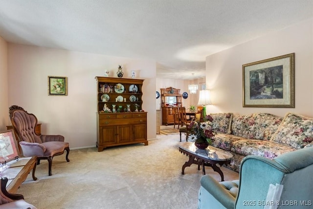 living area featuring baseboards and light colored carpet