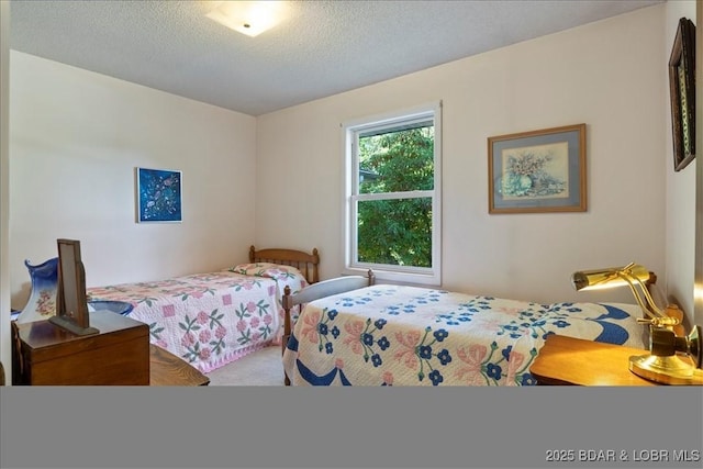 carpeted bedroom featuring a textured ceiling