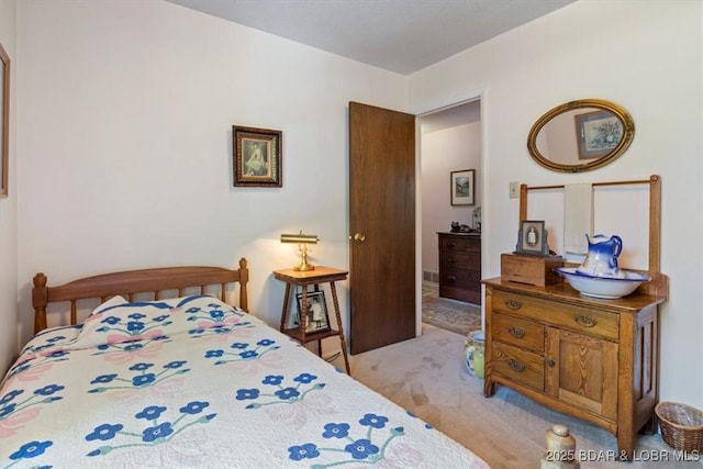 bedroom featuring light carpet