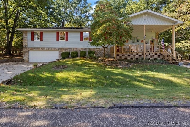 view of front facade featuring an attached garage, covered porch, driveway, and a front lawn