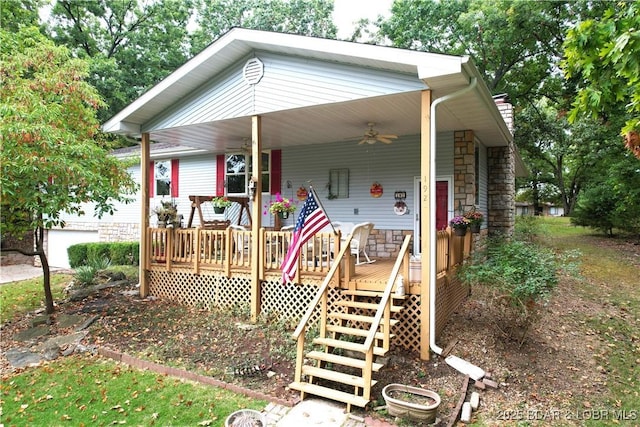 view of front of home with stone siding, covered porch, and a ceiling fan