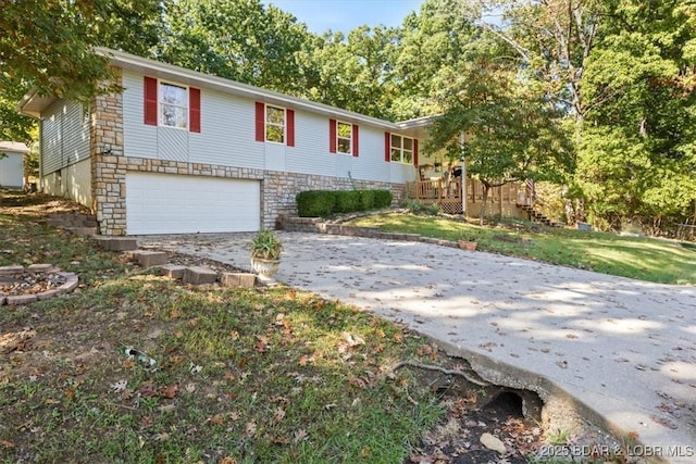 ranch-style house with a garage, stone siding, and driveway