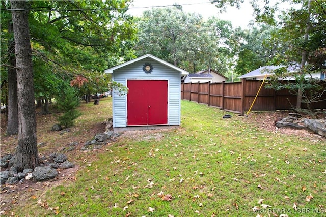 view of shed featuring fence