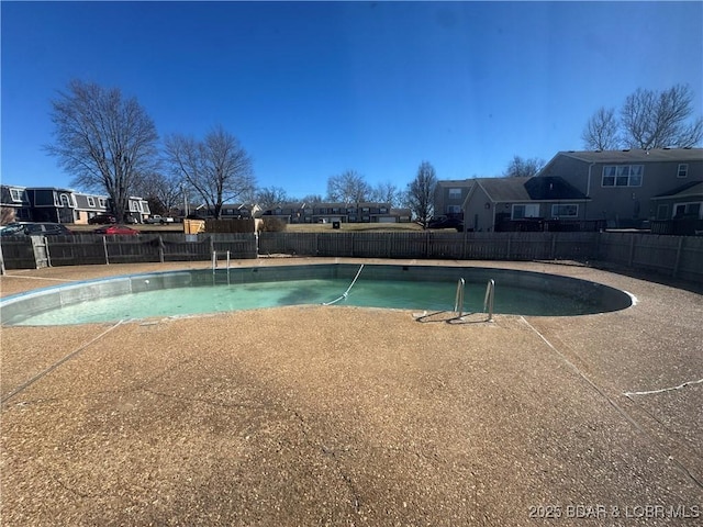 view of swimming pool featuring a residential view, a fenced backyard, and a fenced in pool