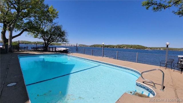 view of swimming pool with fence, a fenced in pool, and a patio