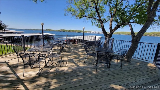 wooden deck featuring a water view