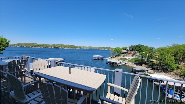 view of dock featuring a water view and a balcony