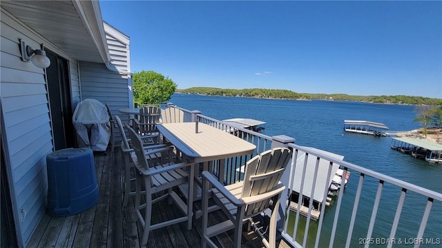 dock area featuring a water view and a balcony