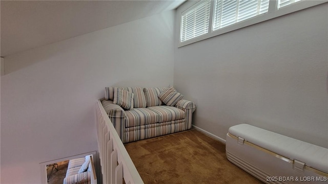 sitting room featuring carpet floors and baseboards